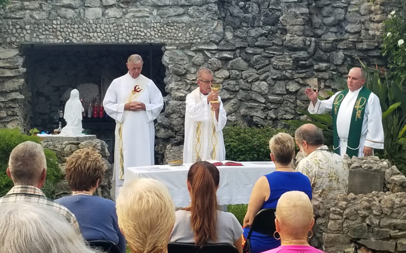 Father John Baker pastor of the Basilica of St. Mary Star of the Sea in Key West, Fla., celebrates an early morning Mass Sept. 7 at the basilica's grotto with special prayers for safety before Hurricane Irma. At left, is Deacon Peter Batty and at right is Father Juan Rumin Dominguez, both from the basilica. (CNS photo/courtesy Basilica of St. Mary Star of the Sea) See IRMA-GROTTO-KEY-WEST Sept. 8, 2017.